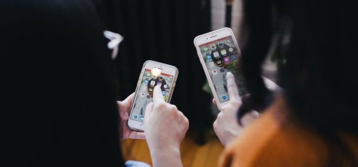 Two people using their phones