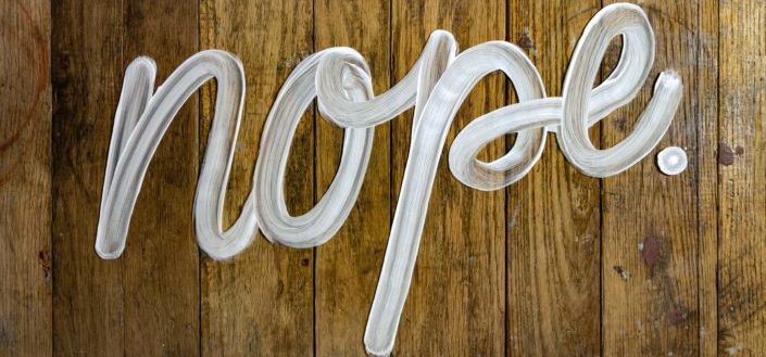 The word nope on wood