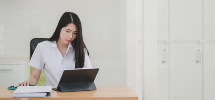 A woman working on her tablet